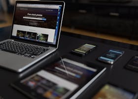 A contemporary workspace showcasing a laptop, tablet, and smartphones, ideal for tech and freelance use.